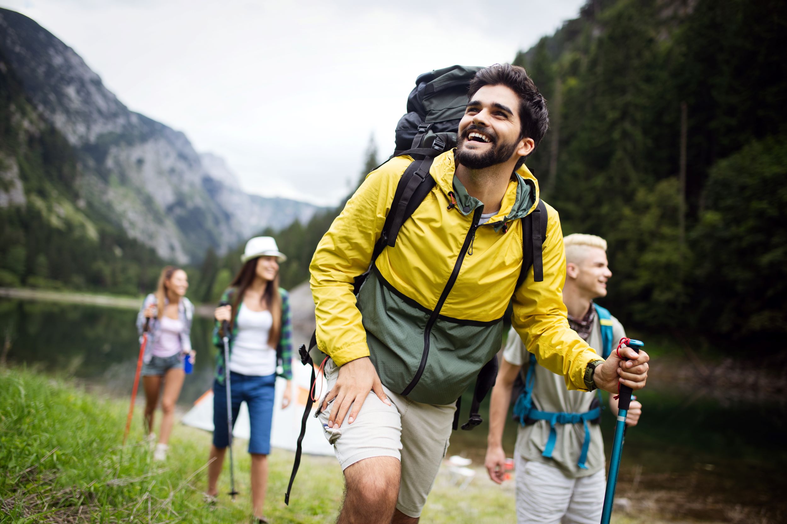 A group of adults hiking in the mountains smiling